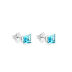 Pendientes de oro blanco con topacio azul en 4 garras talla esmeralda