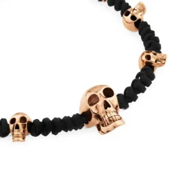 Pulsera de cordon negro con calaveras de oro rosa