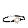 Pulsera de oro rosa y cordón negro con sol de pavé de diamantes