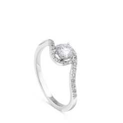 Solitario de oro blanco de 0,29 quilates engastado en 4 garras con orla de pavé de brillantes